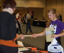 Molly Klinginsmith (Kearney) receives information from a Nebraska university at the 2011 “Show Me the Money” scholarship event.